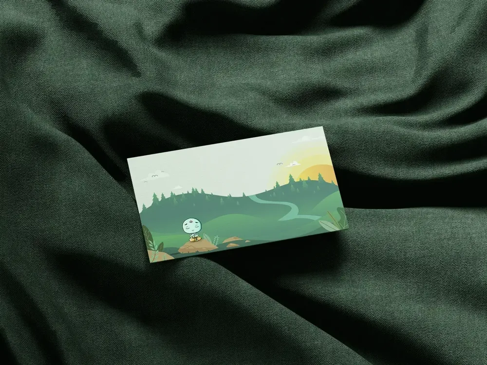 A business card photographed on dark green silk